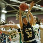 Arlington&rsquo;s Tahlia Miears (32) grabs an offensive rebound away from Bishop Blanchet&rsquo;s Lee Erickson (23) and Annie Maher during a 3A state regional game on Saturday at Mountlake Terrace High School.