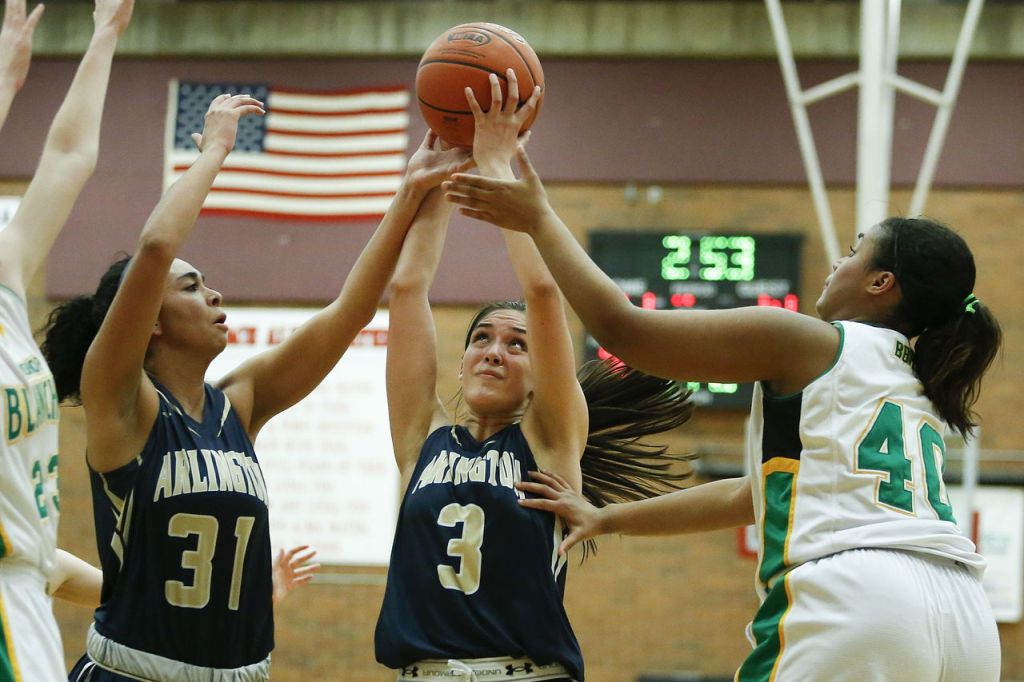 Arlington&rsquo;s Gracie Castaneda (3) grabs a rebound during a 3A state regional game against Bishop Blanchet on Saturday at Mountlake Terrace High School.