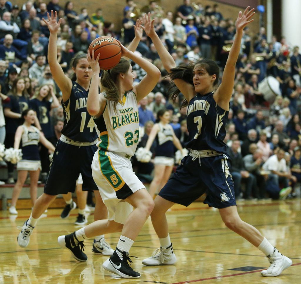 Bishop Blanchet&rsquo;s Lee Erickson (23) tries to find an open player to pass to as Arlington&rsquo;s Peyton Brown (14) and Gracie Castaneda (3) pressure her during a 3A state regional game on Saturday at Mountlake Terrace High School.