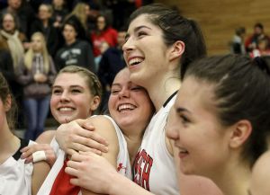 Members of the Snohomish girls basketball team celebrate their 53-40 victory over Gig Harbor in a 4A state regional game on Saturday at Everett Community College.