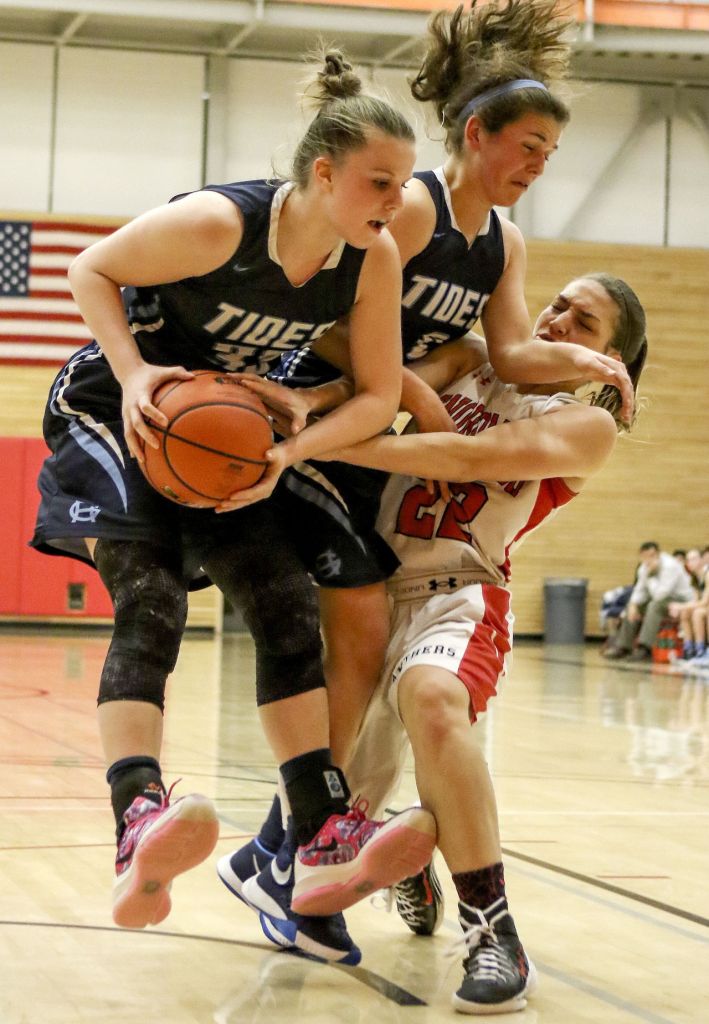 Gig Harbor&rsquo;s Maddie Willett (left) Gig Harbor&rsquo;s Abby Nordquist and Snohomish&rsquo;s Shaylee Harwood fight for a rebound Saturday night during the Panthers&rsquo; 53-40 win in a 4A state regional game at Everett Community College.