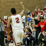 King&rsquo;s fans react to a 3-pointer by Cole Mitchell (2) during a 1A state regional game against Vashon Island on Saturday at Mountlake Terrace High School.