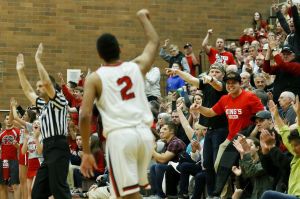 King&rsquo;s fans react to a 3-pointer by Cole Mitchell (2) during a 1A state regional game against Vashon Island on Saturday at Mountlake Terrace High School.