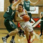 King&rsquo;s Koa Wilkins (center) drives in for a layup during a 1A state regional game against Vashon Island on Saturday at Mountlake Terrace High School.