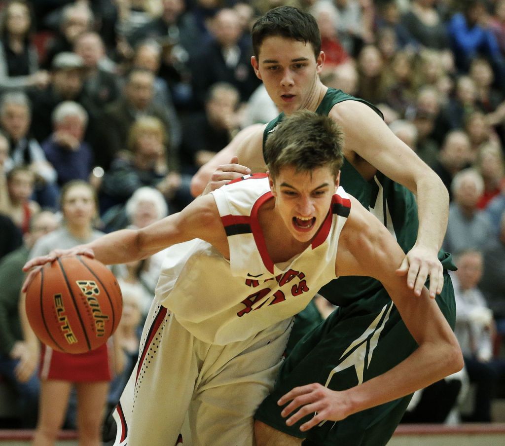 King&rsquo;s Chewy Zevenbergen battles through the defense of Vashon Island&rsquo;s Josh Tillman during a 1A state regional game on Saturday at Mountlake Terrace High School.