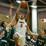 King&rsquo;s Cole Mitchell (2) drives to the hoop as Vashon Island&rsquo;s Sean Delargy (22) and Casper Forest (32) defend during a 1A state regional game on Saturday at Mountlake Terrace High School.
