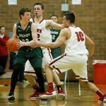 King&rsquo;s Josh Frohardt (center) and Koa Wilkins (right) double-team Vashon Island&rsquo;s Sean Delargy during a 1A state regional game on Saturday at Mountlake Terrace High School.