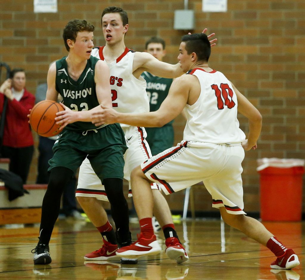 King&rsquo;s Josh Frohardt (center) and Koa Wilkins (right) double-team Vashon Island&rsquo;s Sean Delargy during a 1A state regional game on Saturday at Mountlake Terrace High School.