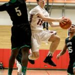 Cascade&rsquo;s Drew Magaoay attempts a shot with Kentwood&rsquo;s Davonte Sanchez defending during a 4A state regional game on Saturday at Everett Community College.