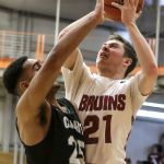 Cascade&rsquo;s Cameron McGrath attempts a shot over Kentwood&rsquo;s Darius Lubom during a 4A state regional game on Saturday at Everett Community College.
