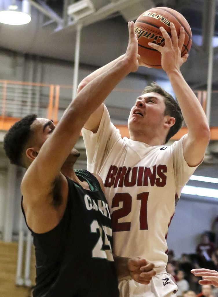 Cascade&rsquo;s Cameron McGrath attempts a shot over Kentwood&rsquo;s Darius Lubom during a 4A state regional game on Saturday at Everett Community College.