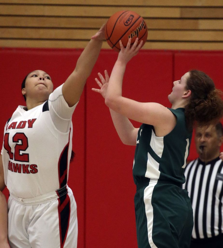 Tulalip Heritage&rsquo;s Adiya Jones blocks Mary M. Knight&rsquo;s Jaycee Valley&rsquo;s shot attempt during a 1B state regional game Saturday at Everett Community College. Tulalip Heritage won 54-42.