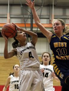 Lynnwood&rsquo;s Jordyn Edwards (left) attempts a shot over West Seattle&rsquo;s Jenna McPhee during a 3A state regional game Saturday afternoon at Everett Community College. Lynnwood won 59-34.