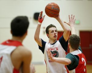 King&rsquo;s Josh Frohardt (center) takes a shot during practice for the state quarterfinals at King&rsquo;s High School on Tuesday.
