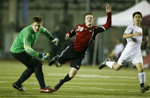 Snohomish&rsquo;s Jason Fairhurst (20) collides with Cascade goalkeeper Scott Pease during the second half of a Wesco 4A boys soccer match on Tuesday at Everett Memorial Stadium.