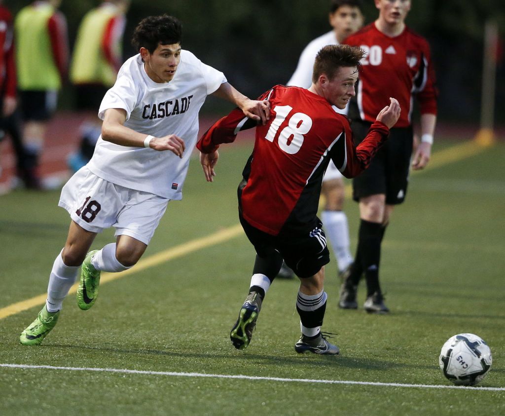 Cascade&rsquo;s Hector Martinez (left) sneaks the ball past Snohomish defender Thomas McKeown during a Wesco 4A boys soccer match on Tuesday at Everett Memorial Stadium.