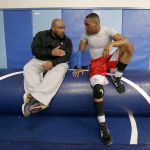 Sultan wrestler Jamell Carroll II listens to his father Jamell Carroll, Sr., an assistant coach, during practice Tuesday at Sultan High School.