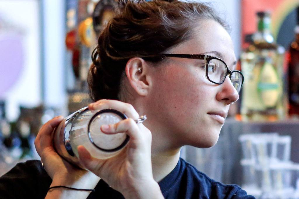 Addie Wilson shakes a cocktail at Cinebarre. (Kevin Clark / The Herald)