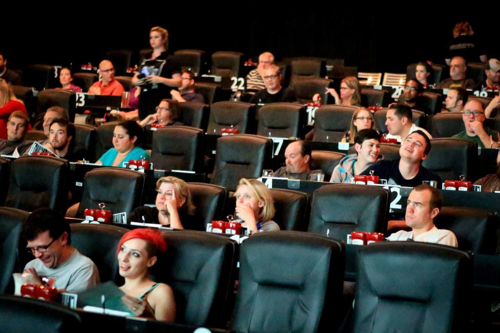 Movie-goers watch the pre-preview show at Cinebarre. (Kevin Clark / The Herald)