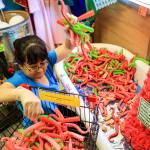 Jackie Sugita works to empty the tentacle display last month at Archie McPhee in the Wallingford neighborhood of Seattle. (Kevin Clark / The Herald)