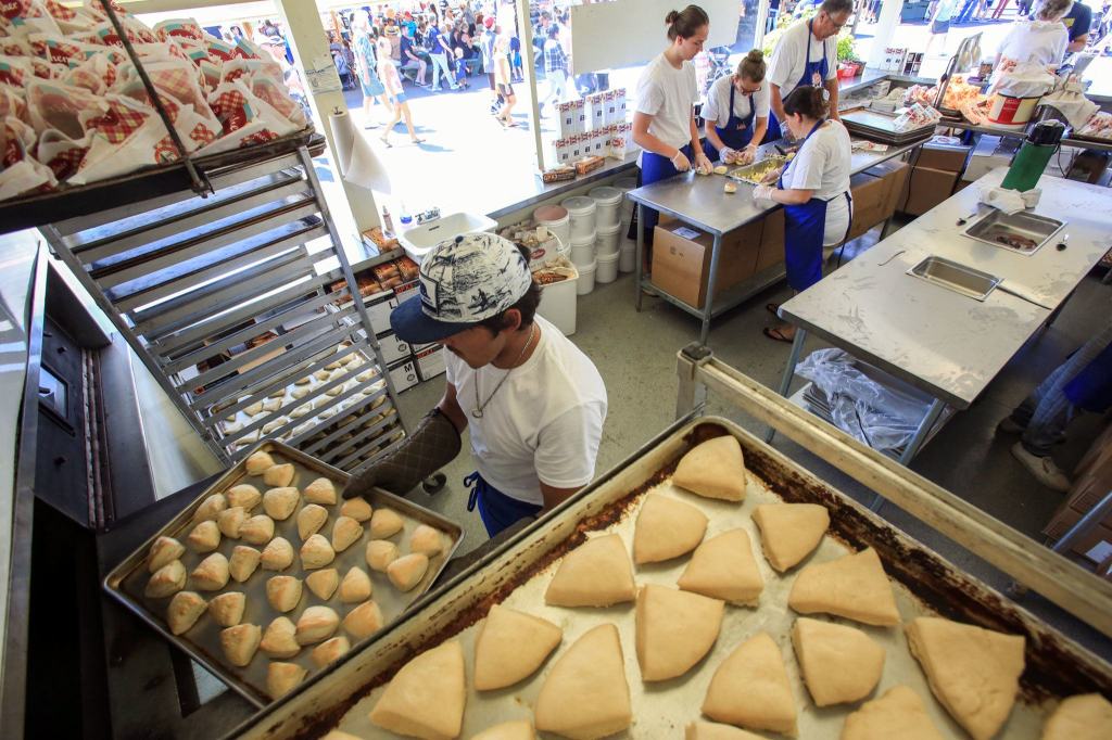 Cisco Martinez unloads fresh scones at Fisher Scones on the first day of the state sair. (Kevin Clark / The Herald)