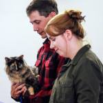Josh Gering holding Juniper with Sara Gering attend the Paws, Prayers and Praise worship service at Saint Aidan&rsquo;s Episcopal Church Sunday afternoon on Camano Island on Aug. 28. (Kevin Clark / The Herald)