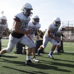 Tre Seargent (second from right) and other Sultan High School football players go through a defensive drill during a practice on Friday, Aug. 26. (Ian Terry / The Herald)
