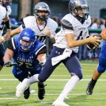 Glacier Peak&rsquo;s Ayden Ziomas scrambles to avoid a pass rush by Bothell&rsquo;s Justin Prachar during a game Thursday night at Pop Keeney Stadium in Bothell. (Kevin Clark / The Herald)