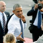 U.S. President Barack Obama greets military personnel after he arrives on Air Force One at Joint Base Pearl Harbor-Hickam on Wednesday in Honolulu. (AP Photo/Marco Garcia)