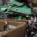 Piles of wires, motherboards and other electronic parts fill boxes at E-Waste Recycling Center, in December 2014. (Genna Martin / Herald file photo)