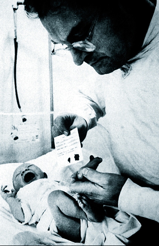 Newborn screening involves jabbing a baby&rsquo;s heel to get drops of blood. In a 1970s photo Dr. Robert Guthrie demonstrates why the technique is sometimes dubbed &ldquo;newborn screaming.&rdquo; (Courtesy of the Guthrie Family)