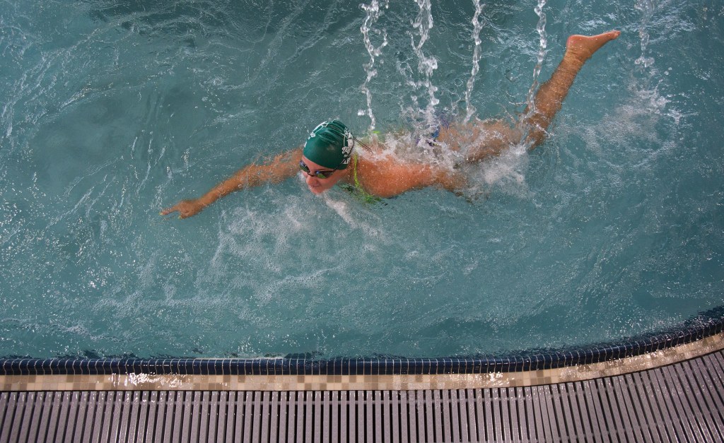 Aleena Wiegand, 13, swims under fountains of water in the Lazy River area of the pool during the Grand Opening of the Stanwood-Camano YMCA on Sept. 3, 2016, in Stanwood. (Andy Bronson / The Herald)