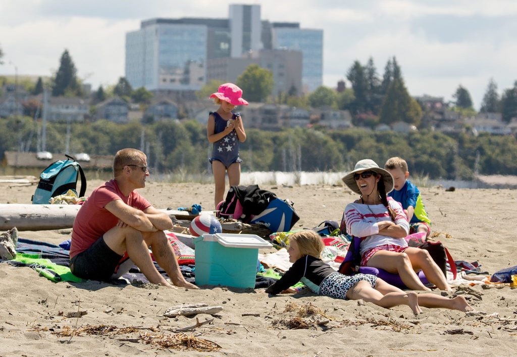 Parents and kids enjoy the beach life on Jetty Island in Everett. (Andy Bronson / The Herald)