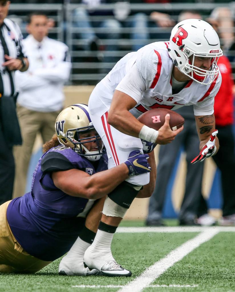 Rutgers&rsquo; Chris Laviano is sacked by Washington&rsquo;s Elijah Qualls on Saturday afternoon at Husky Stadium. (Kevin Clark / The Herald)