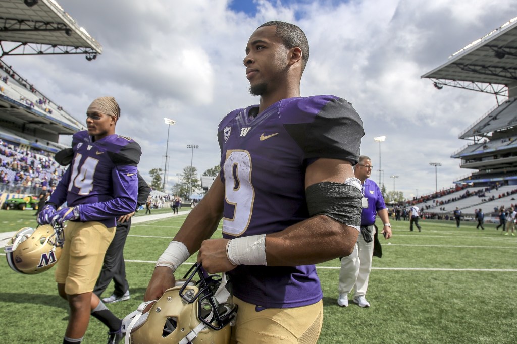 Husky Myles Gaskin walks off the field after the game against the Rutgers Scarlet Knight Saturday afternoon at Alaska Airlines Field at Husky Stadium on September 3, 2016. The UW Huskies defeated the Rutgers Scarlet Knights 48-13. (Kevin Clark / The Herald)