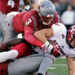 Eastern Washington wide receiver Cooper Kupp (right) is brought down by Washington State defensive back Darrien Molton (3) and defensive back Trey Tinsley (10) during the first half of a game Saturday in Pullman. (AP Photo/Young Kwak)