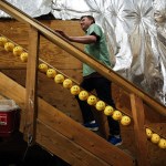 David Wahl, Director of Awesome at Archie McPhee, walks up a staircase at the Archie McPhee warehouse in Mukilteo. Wahl started at the company packing boxes 21 years ago and now plays an important role in coming up with new concepts and ideas. (Ian Terry / The Herald)