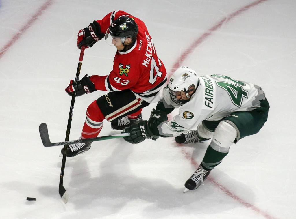 Portland&rsquo;s Skyler McKenzie attempts a shot at goal with Everett&rsquo;s Gianni Fairbrother trailing in the third period Sunday night at Xfinity Arena in Everett on September 4, 2016. (Kevin Clark / The Herald)