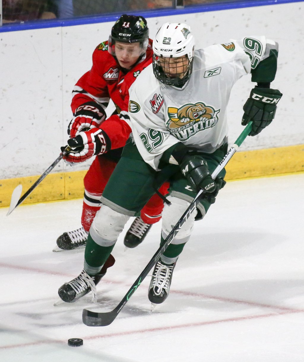 Everett&rsquo;s Wyatte Wylie controls the puck under pressure from Portland&rsquo;s Bronson Sharp during Sunday night&rsquo;s game at Xfinity Arena. (Kevin Clark / The Herald)