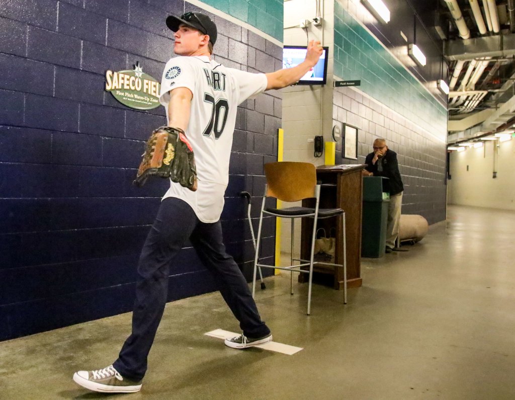 Silvertips goaltender Carter Hart practices his ceremonial first pitch before the Mariners game against the Rangers on Wednesday night at Safeco Field in Seattle. (Kevin Clark / The Herald)