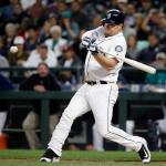 The Mariners&rsquo; Adam Lind swings for a grand slam against the Rangers in the first inning of a game Wednesday in Seattle. The Mariners beat the Rangers 8-3. (AP Photo/Elaine Thompson)