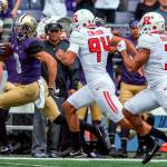 Washington&rsquo;s Dante Pettis scores on a 68-yard punt return with Rutgers&rsquo; Michael Cintron (94) and Jawuan Harris (3) trailing during a game Sept. 3 at Husky Stadium. (Kevin Clark / The Herald)