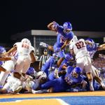Boise State running back Jeremy McNichols (13) leaps into the end zone for a touchdown during the first half of a game against Washington State on Saturday in Boise, Idaho. The Broncos beat the Cougars 31-28. (AP Photo/Otto Kitsinger)