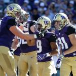 Teammates greet Washington running back Myles Gaskin (9) after Gaskin scored a touchdown against Idaho in the first half of a game Saturday in Seattle. (AP Photo/Ted S. Warren)