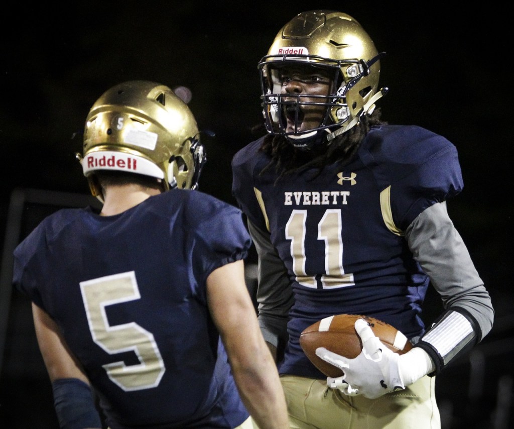 Everett&rsquo;s Louis Davis (11) celebrates a catch with teammate Brett Allred (5) during a game against Meadowdale at Everett Memorial Stadium on Friday. (Ian Terry / The Herald)