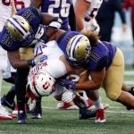 Stanford running back Christian McCaffrey (5) is tackled by Washington linebacker Azeem Victor (36) and defensive lineman Elijah Qualls in the first half of a game Friday in Seattle. (AP Photo/Ted S. Warren)