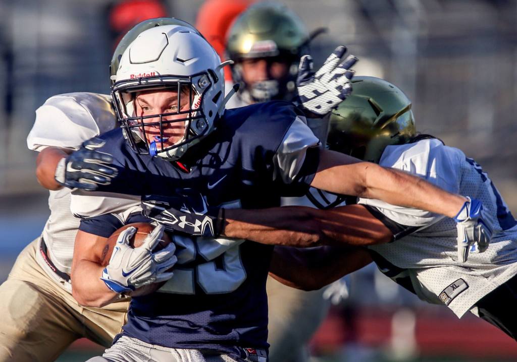 Squalicum&rsquo;s Triston Smith attempts to break Everett tackles during the 3rd Annual Squalicum Jamboree this past Saturday afternoon in Bellingham. (Kevin Clark / The Herald)