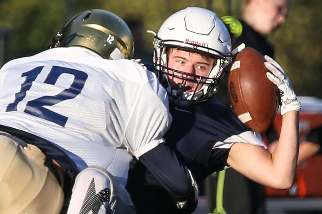 Squalicum&rsquo;s Noah Westerhoff makes a catch with Everett&rsquo;s Jaden Goodrich making a tackle during the 3rd Annual Squalicum Jamboree this past Saturday afternoon in Bellingham. (Kevin Clark / The Herald)