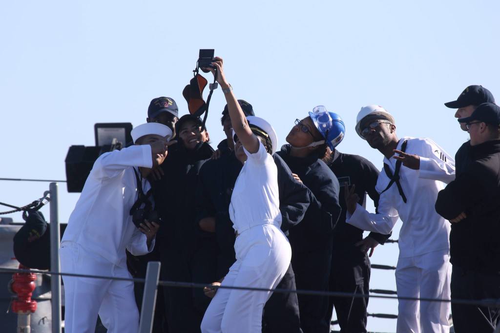 An officer and crew pose for a group photo as the USS Sampson (DDG 102) arrives at Naval Station Everett on Monday. (Andy Bronson / The Herald)