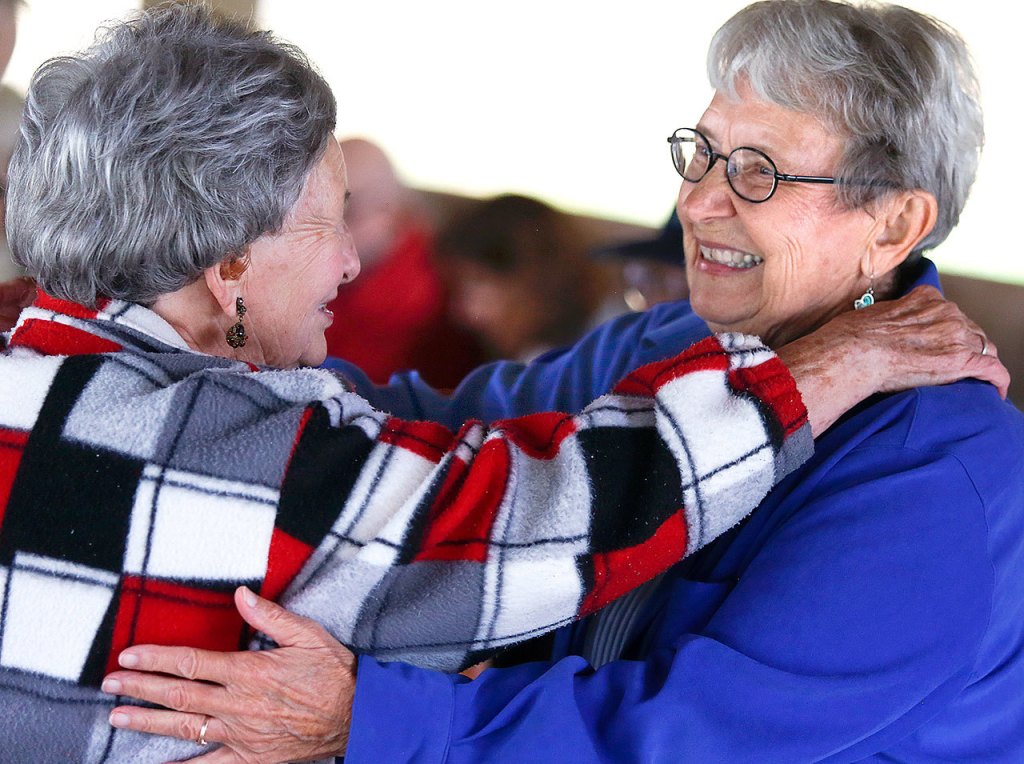 Before going back to their own lives following the renunion, Milly Krause, 92, (left) and Elinore Bisnett, 88, embrace and take a long, kind look at one another. (Dan Bates / The Herald)